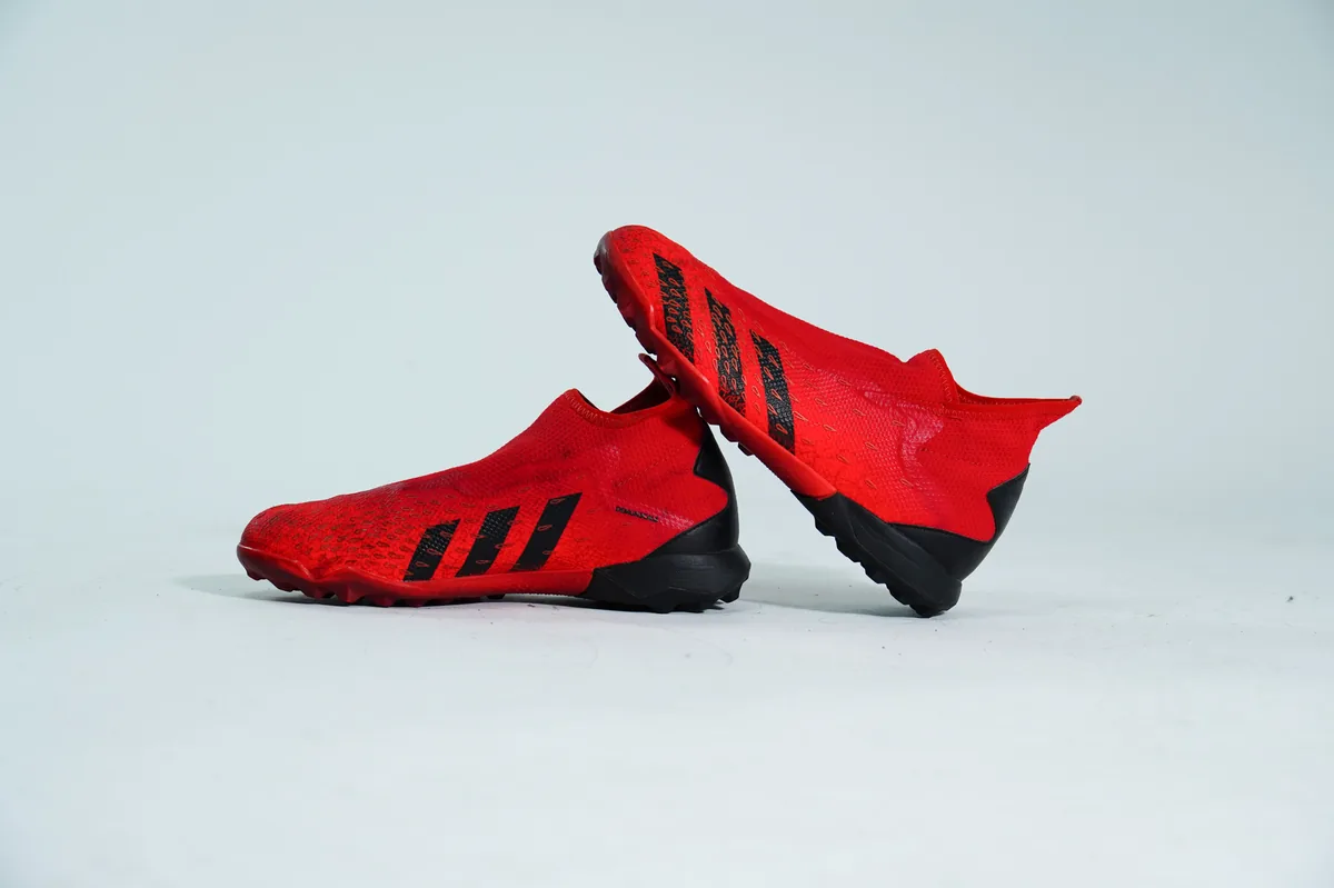 Foto de producto para e-commerce: tacos de futbol rojos de malla en estudio, toma 119
