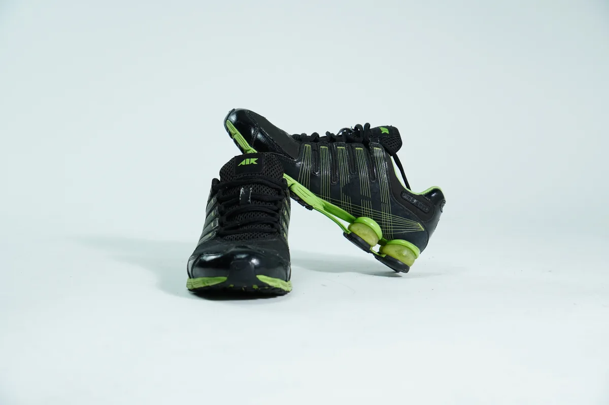 Foto de producto para e-commerce: tenis deportivos verde con negro en estudio, toma 95