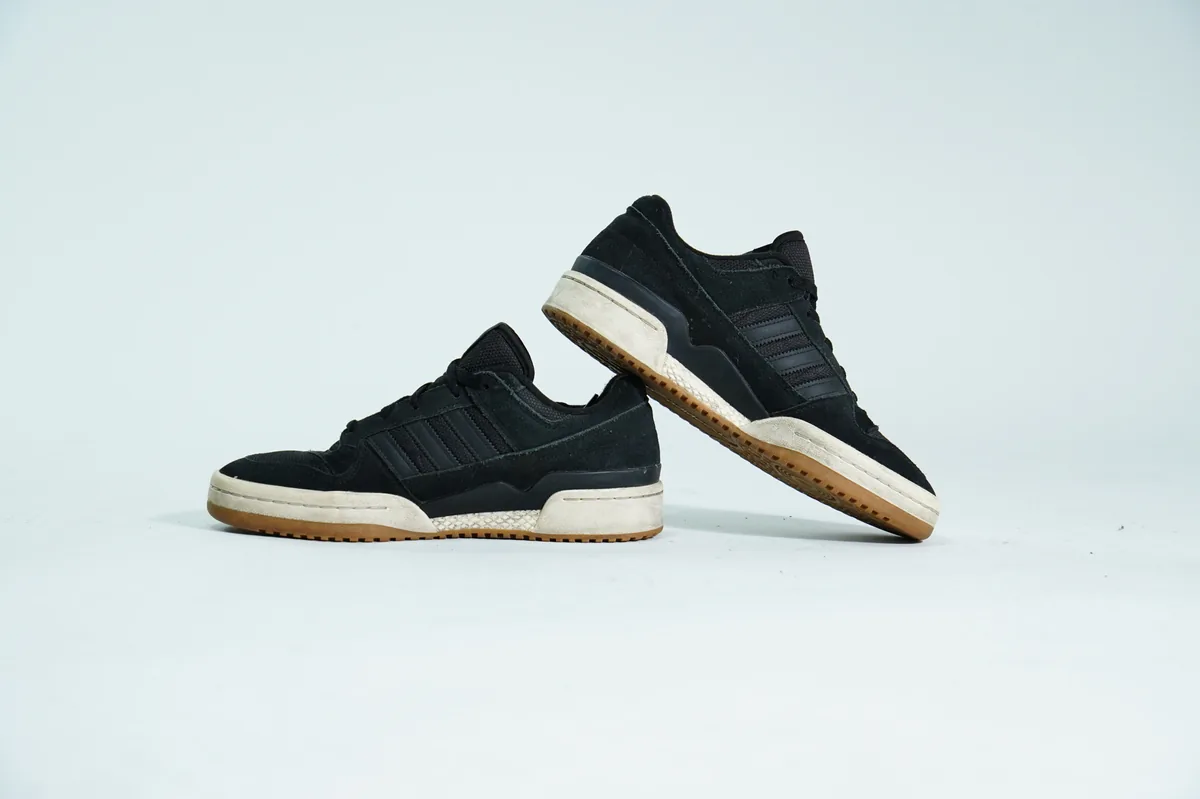 Foto de producto para e-commerce: tenis negros con suela de goma en estudio, toma 122