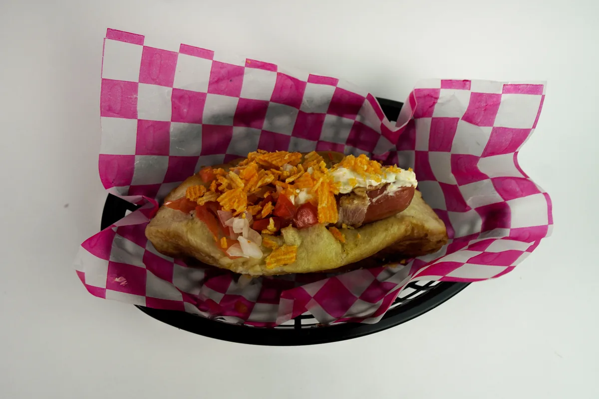 Fotografía de alimentos en estudio: hot dog con tocino sobre fondo blanco, toma 53