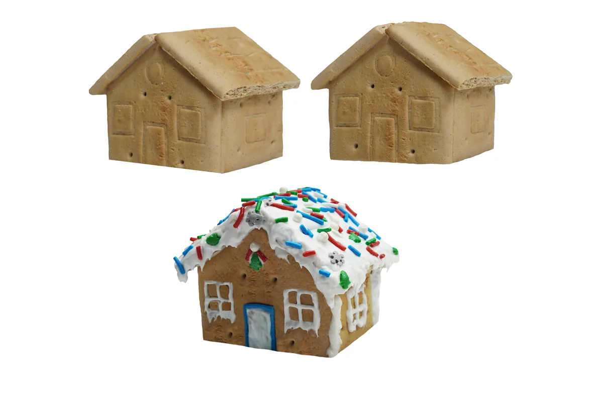 Fotografía de producto recortada sobre fondo blanco: casita de galleta de jengibre con betún y chispas