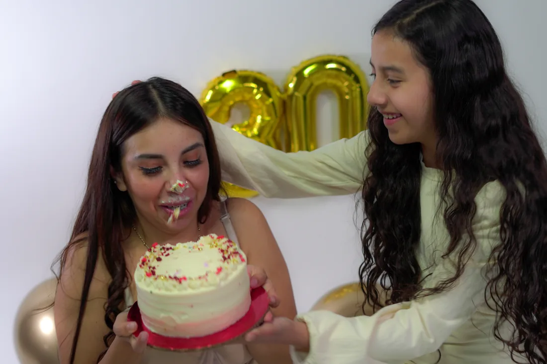 Sesión de fotos de cumpleaños en estudio con vestido nude y una amiga sobre fondo blanco, toma 90